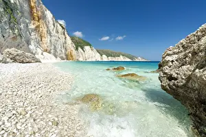 Waves of the turquoise clear sea washing the white stones of Fteri Beach, Kefalonia, Ionian Islands, Greek Islands, Greece, Europe