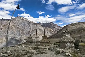 Burial Ground Prints: Weathered Buddhist chortens at Neyrak village looking over cliff, Zanskar, India