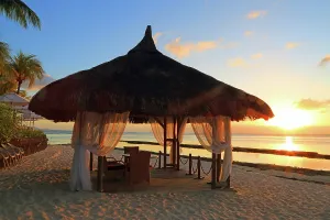 Love Prints: Wedding gazebo at sunset in Mauritius by the beach near calm waters