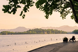 West Lake Prints: West Lake shore with hilly landscape and silhouettes, Hangzhou, Zhejiang, China, Asia