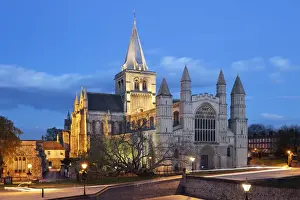 The west front of the Norman built Rochester Cathedral floodlit at night, Rochester, Kent