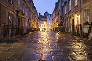 Wet paving stones and Georgian houses along the North Parade buildings, Bath