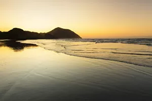 Silhouetted Gallery: Wharariki Beach at sunset, Golden Bay, Tasman, South Island, New Zealand, Pacific