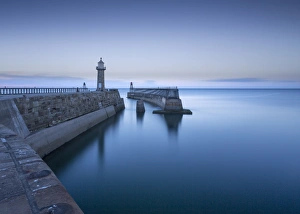 Whitby piers and lighthouses, shortly after sunset, Whitby, North Yorkshire, England