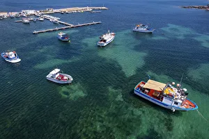 Siracusa Province Prints: White and blue fishing boats in the water of Marzamemi harbour