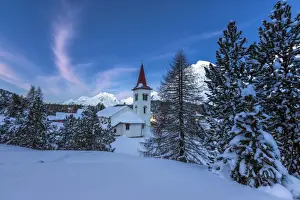 Chiesa Bianca Prints: The white church of Maloja Pass in the winter fairy-tale landscape of the Engadine Valley at the blue hour