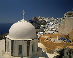 Fira Prints: The white dome of a chapel and an ochre painted balcony