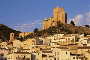 Whitewashed village houses dwarfed by the Castillo Whitewashed village houses dwarfed by the Castillo