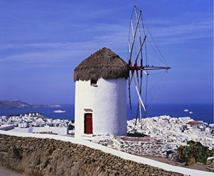 Cyclades Prints: Windmill and View of Mykonos by the Coast, Cyclades, Greece