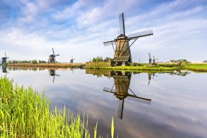 Traditionally Dutch Prints: Windmills reflection on the canal and grass in the foreground, Kinderdijk, UNESCO