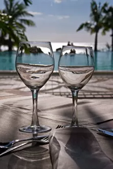 Images Dated 6th September 2007: Wine glasses in front of the pool of the Beachcomber Le Paradis, Mauritius