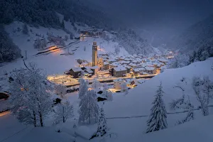 Valgerola Prints: Winter dusk over the illuminated village in deep snow, Gerola Alta, Valgerola