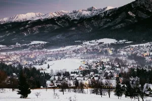 Poland Prints: Winter night scene with snow-covered mountains and village lights in Zakopane