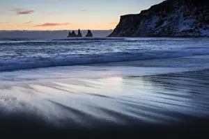 Reynisdrangar Prints: Winter sunset on black volcanic sand beach looking towards rock stacks of Reynisdrangar