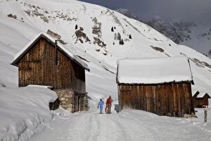 Images Dated 11th December 2010: Winter walk on snowy path through wooden barns around San Pellegrino Pass