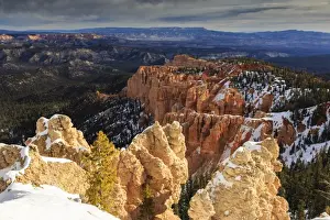 Hoodoo Prints: Wintry cliffs and hoodoos strongly lit by morning sun with cloudy backdrop