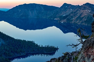 Wizard Island and the still waters of Crater Lake at dawn, the deepest lake in the U