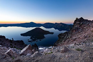 Wizard Island and the still waters of Crater Lake at dawn, the deepest lake in the U