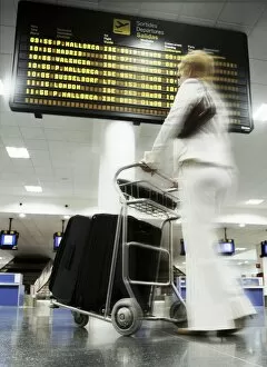 Images Dated 1st February 2010: Woman with baggage trolley in departures, Ibiza Airport, Spain, Europe