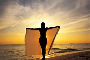 Woman on a beach at sunset, Maldives, Indian Ocean, Asia