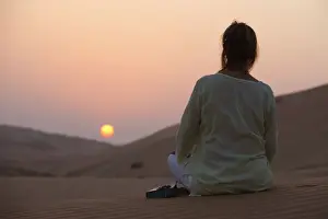 View From Behind Prints: Woman with Bible in the desert, Abu Dhabi, United Arab Emirates, Middle East