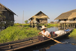 Stilt Prints: Woman in canoe paddles past floating village, Inle Lake, Shan State, Myanmar (Burma)
