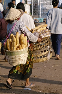 Carrying Prints: Woman carrying two baskets of French bread in the Talaat
