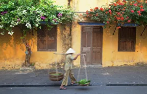 South East Asian Prints: Woman carrying vegetables in street