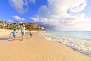 35 39 Years Gallery: Woman and children running happily on Ffryes Beach, Antigua, Antigua and Barbuda