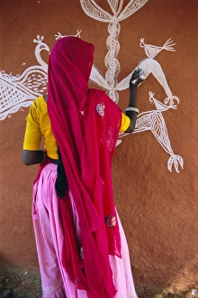 Woman decorating her house with traditional local designs