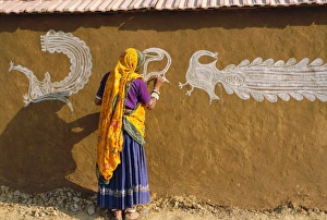 Dres Prints: Woman decorating her house with traditional local designs