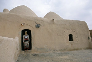 Single Storey Prints: Woman in doorway of a 200 year old beehive house in the desert