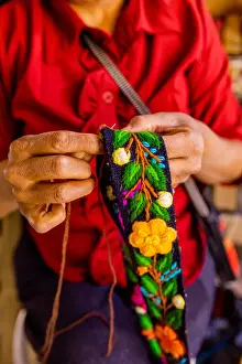 Human Hand Prints: Woman embroidering traditional Alpaca wool hat band, Ayacucho, Peru, South America