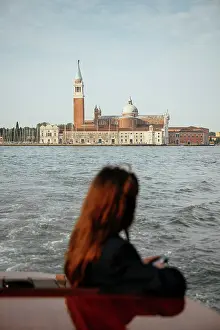 Enjoyment Prints: Woman enjoys boat ride with San Giorgio Maggiore view in Venice