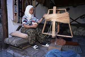 Carpet Prints: Woman gathering dyed wool in carpet workshop