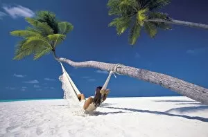 Woman in hammock on beach, Maldives, Indian Ocean, Asia