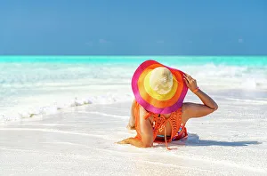Dress Prints: Woman with hat relaxing on idyllic empty beach, Zanzibar, Tanzania, East Africa, Africa