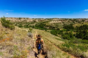35 39 Years Gallery: Woman hiking along The Petrified Forest Loop Trail inside Theodore Roosevelt National