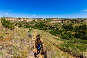 35 To 39 Years Prints: Woman hiking along The Petrified Forest Loop Trail inside Theodore Roosevelt National