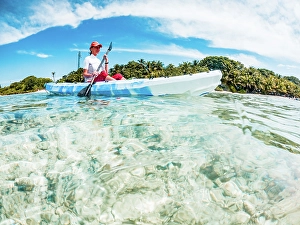 Brightness Prints: Woman kayaking in clear tropical sea, summer fun, The Maldives, Indian Ocean
