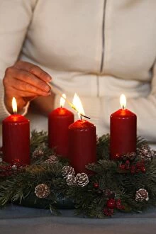 Woman lighting advent candles, Saint Nicolas de Veroce, Haute Savoie, France, Europe