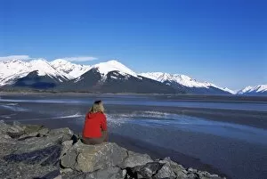 Woman looking at glaciers along the s eward Highway