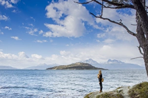 Contemplation Gallery: Woman looking out over the Magellan Straits and Darwin Mountain range in Tierra del