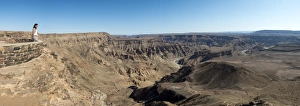 Contemplating Gallery: A woman looks into The Fish River Canyon in southern Namibia, Africa