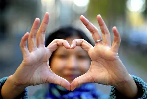 Images Dated 14th October 2007: Woman making a heart with her fingers, Paris, France, Europe