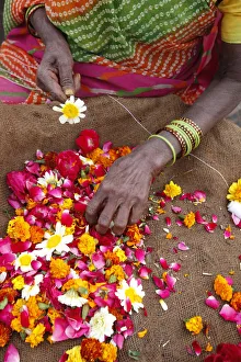 Indian Culture Gallery: Woman making and selling garlands outside a Hindu temple, Goverdan, Uttar Pradesh, India