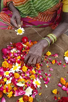Selling Prints: Woman making and selling garlands outside a Hindu temple, Goverdan, Uttar Pradesh, India