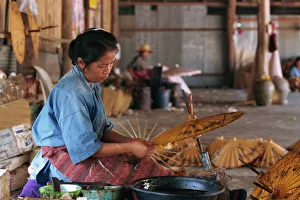 Umbrella Prints: Woman making umbrellas with brown paper at the Umbrella