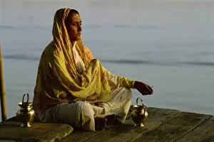 Woman meditating on the banks of the River Ganges, Varanasi, Uttar Pradesh state