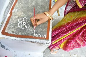 Images Dated 17th October 2009: Woman painting her doorstep with rice flour paste, making rangoli design Diwali Festival